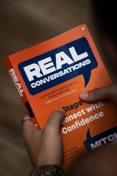 Real Conversations book held in hand